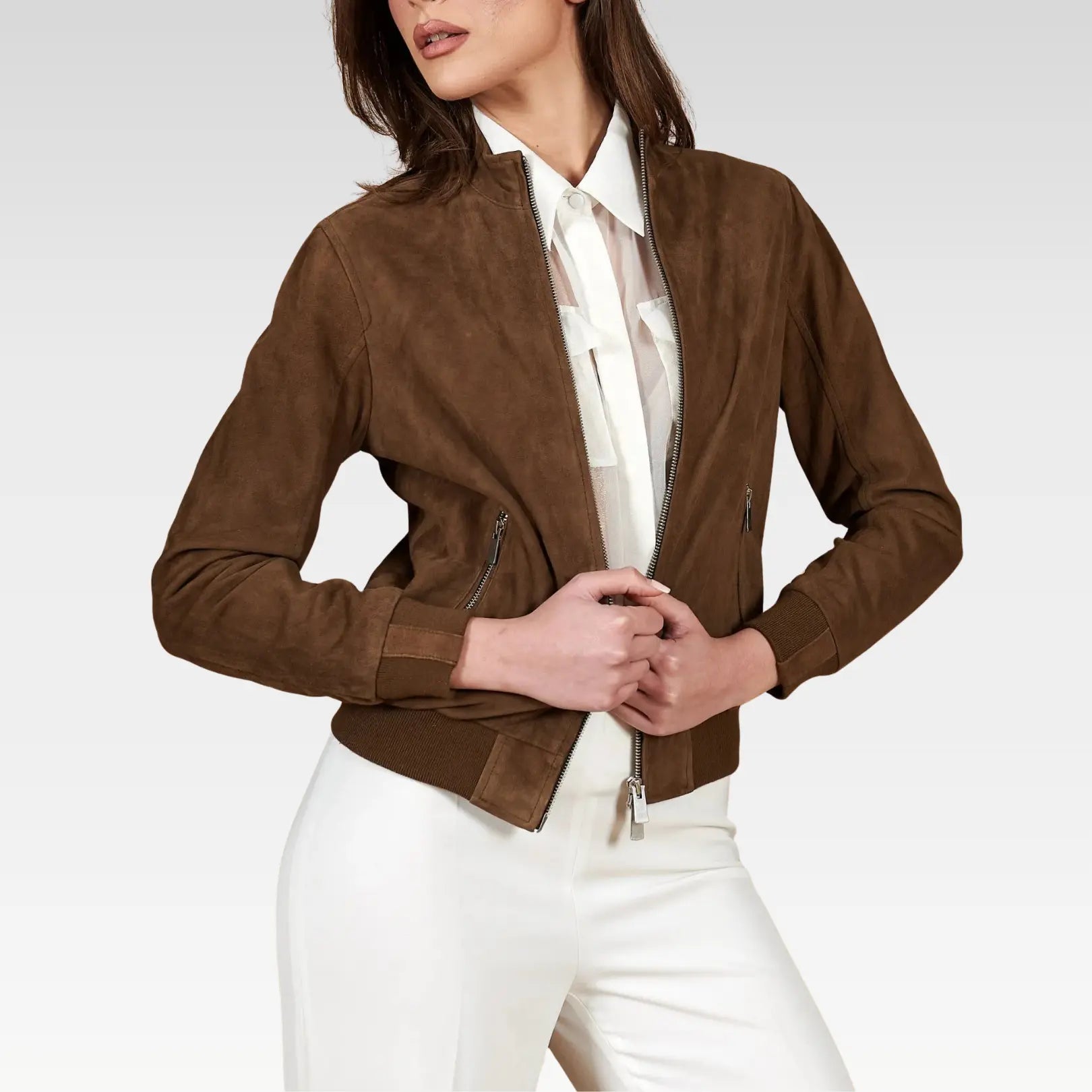 Woman wearing a brown jacket over a white shirt and pants on a light gray background