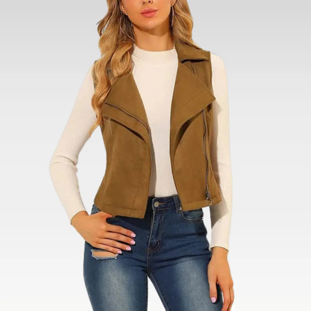 Woman wearing camel brown suede leather vest, front view with white top and jeans