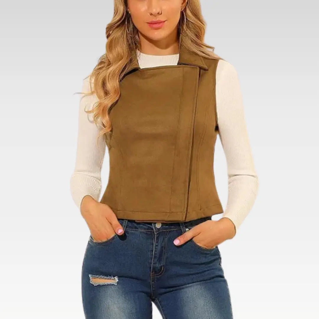 Side angled view of woman wearing camel brown suede leather vest, styled with white top and jeans