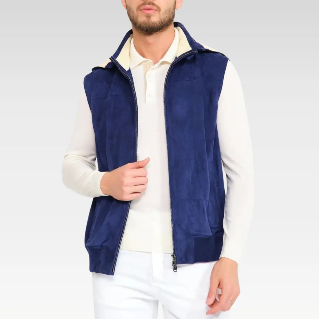 Male model wearing a navy suede leather vest with front zipper open, styled over a white sweater