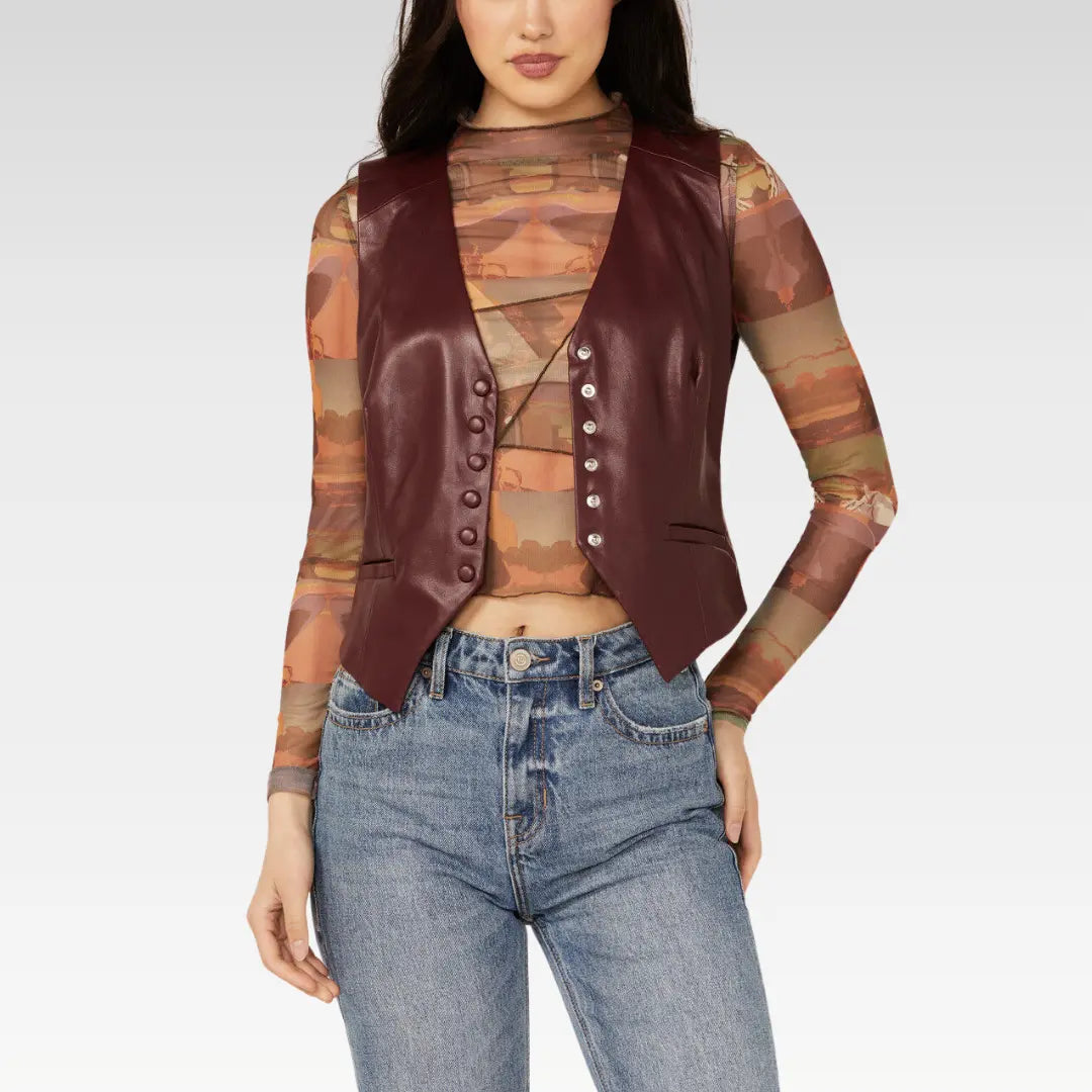 Model wearing the Revel women's burgundy lambskin leather vest with a button-down front, styled over a mesh top and jeans.