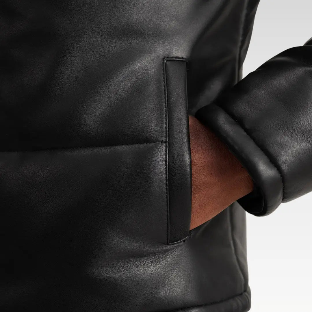 Close-up of the Gordon Black Hooded Leather Puffer Jacket showing genuine sheepskin texture and high-quality stitching detail.