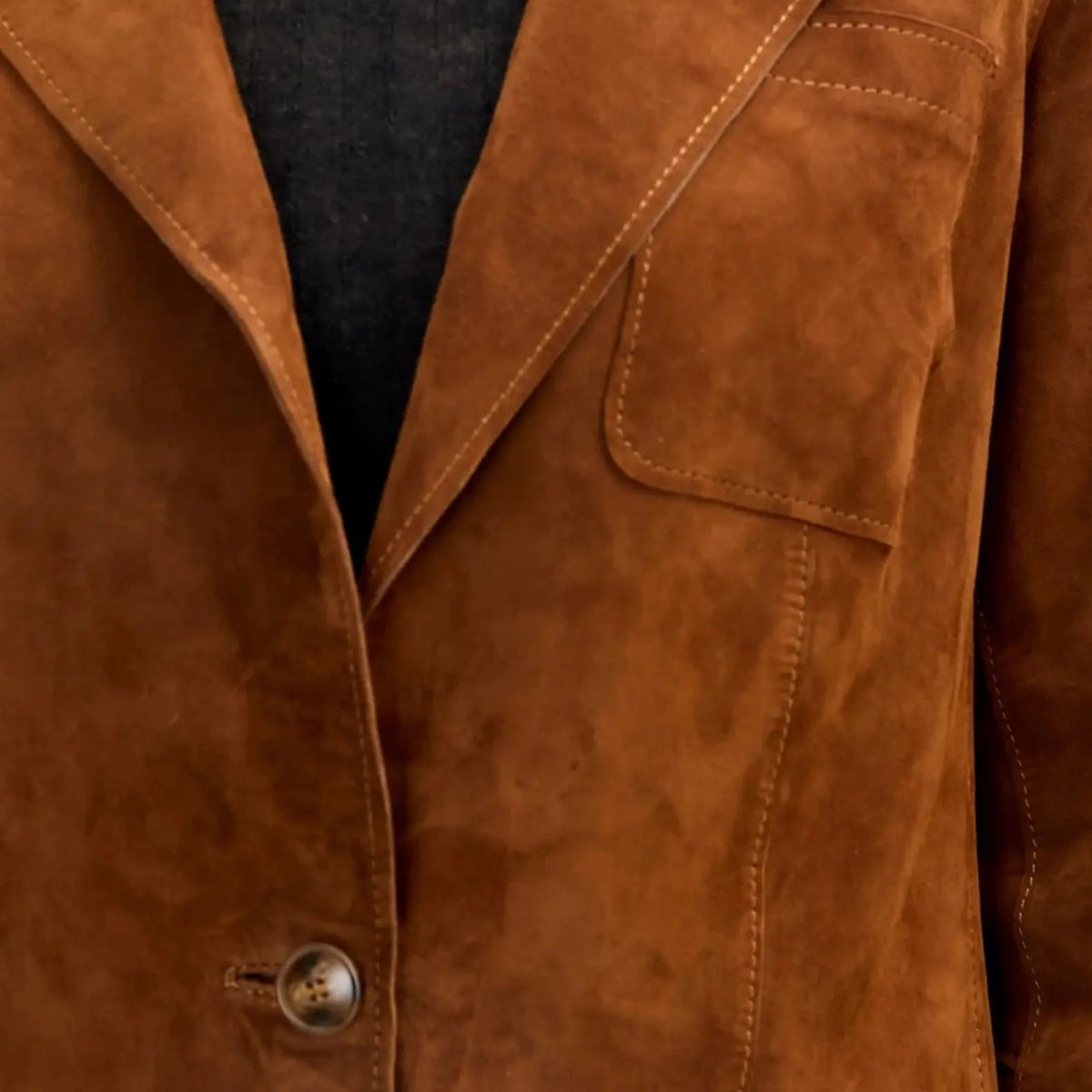 Side view of brown suede lambskin blazer highlighting relaxed fit, soft suede material, and lapel details.