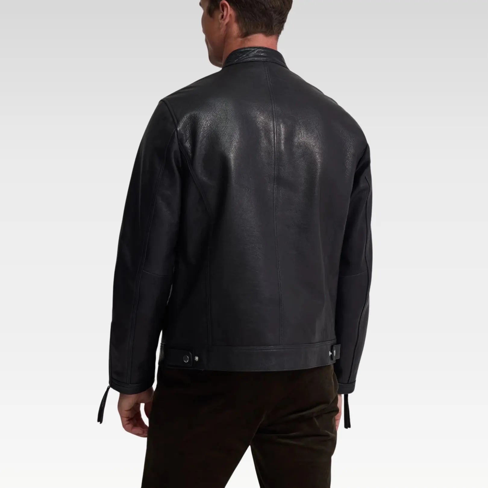 Back view of Oryn biker leather jacket in 100% genuine black leather, featuring tailored slim fit and round neckline with buckle tab.