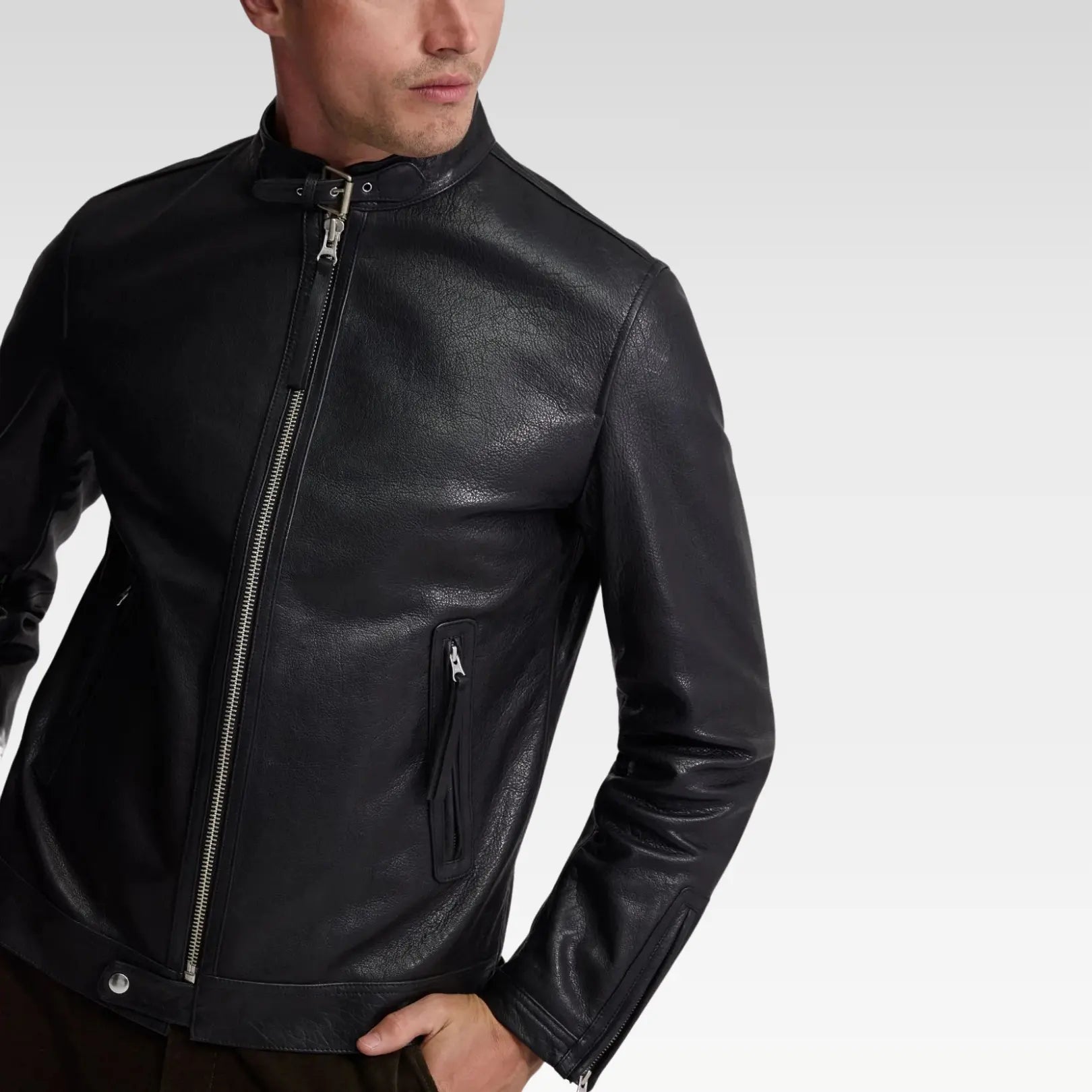 Three-quarter angle of Oryn biker leather jacket, highlighting premium craftsmanship, sleeve zippers, and metallic hardware accents.