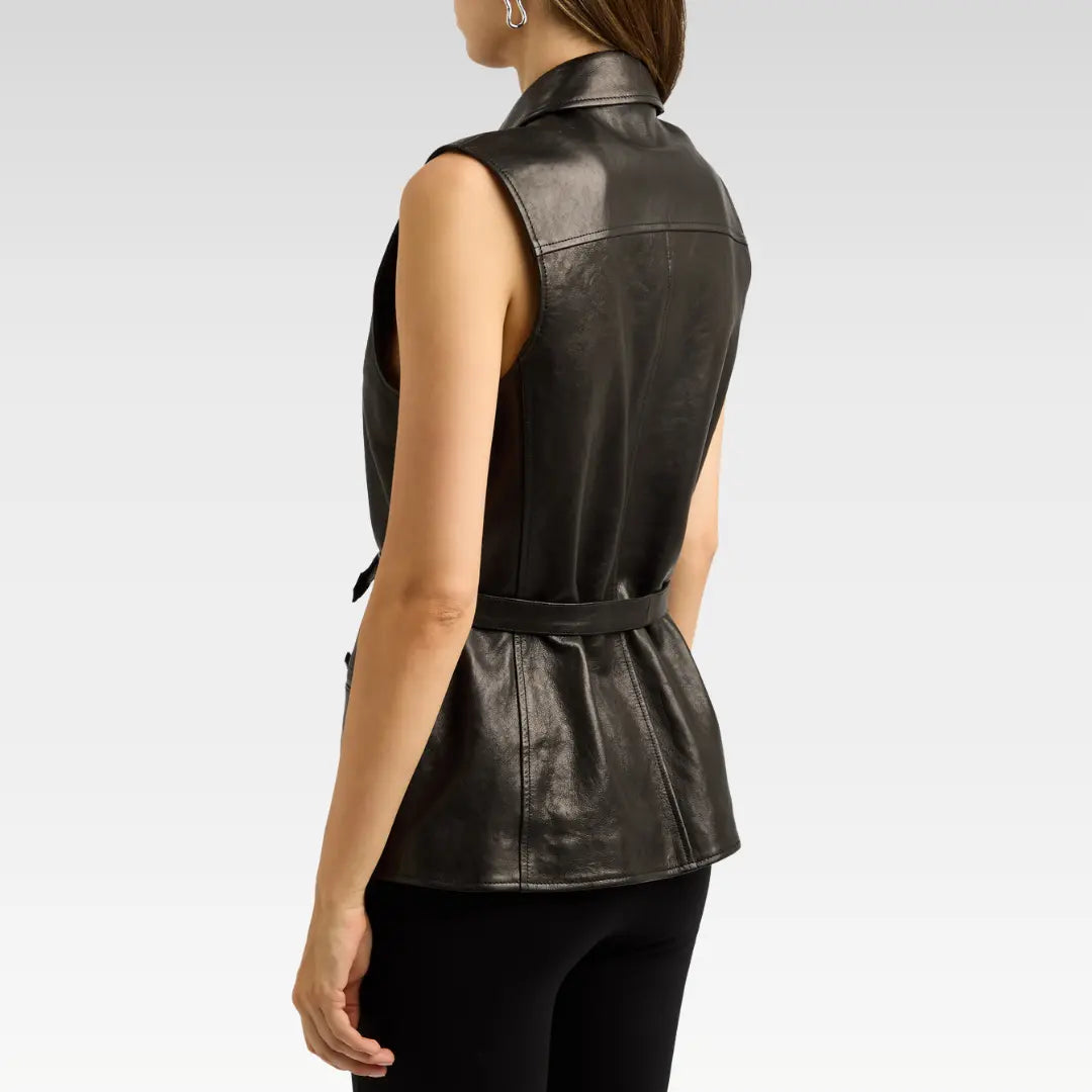 Side profile of a woman wearing a structured black sheepskin leather vest showing the tailored fit and smooth leather texture.