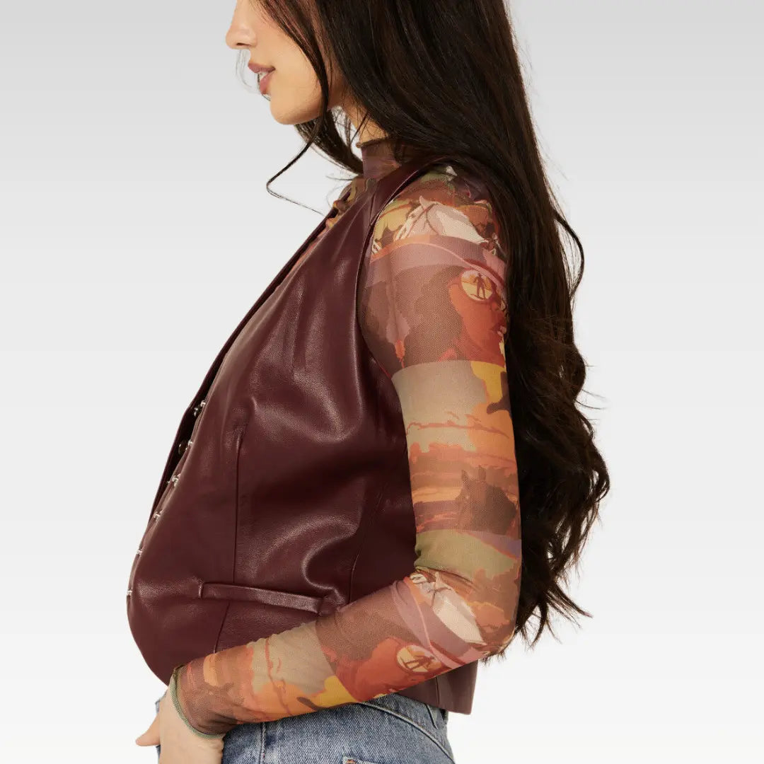 Side profile of the Revel burgundy lambskin vest, highlighting its smooth finish and structured cut.