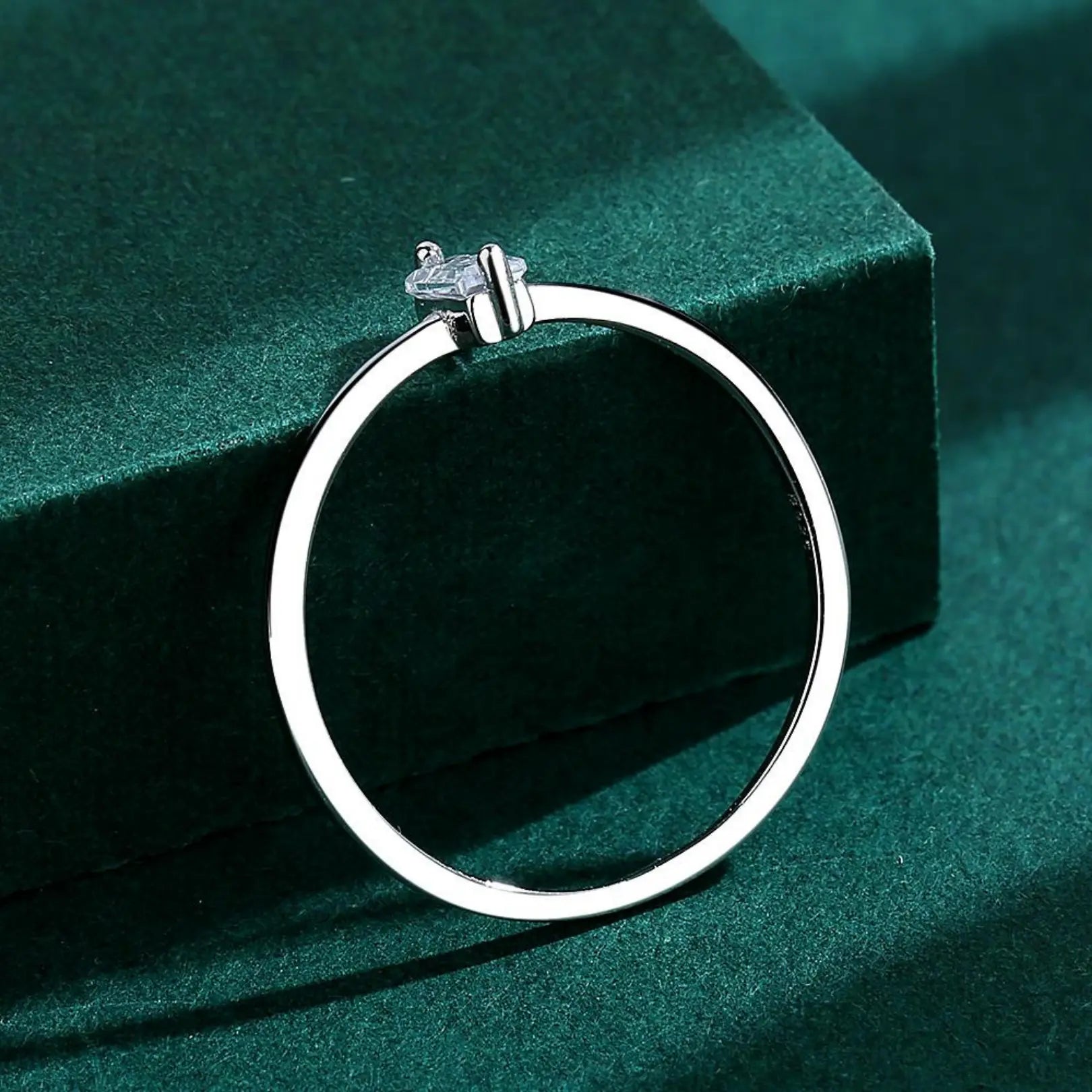  Simple shiny zircon ring with a slim silver band, perfect for daily wear or stacking.