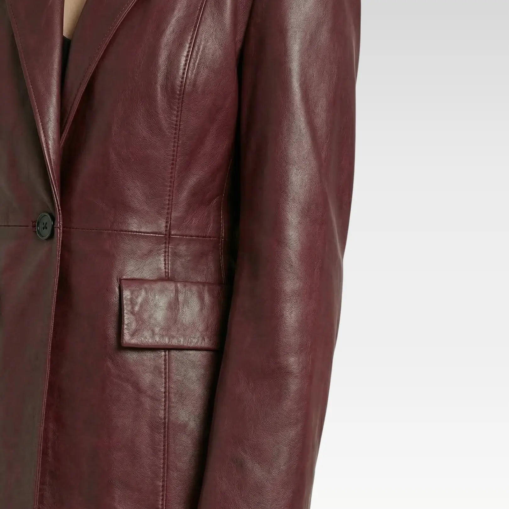 Side view of burgundy leather blazer showing flap pocket detail