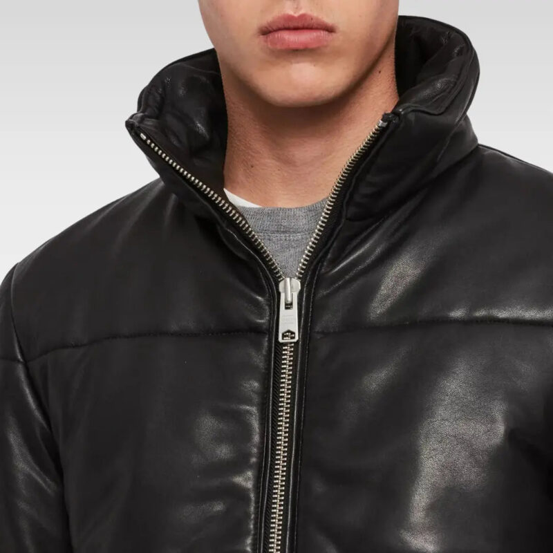 Close-up of the Amine Black Puffer Leather Jacket collar and zipper, showing smooth leather finish and sleek craftsmanship.