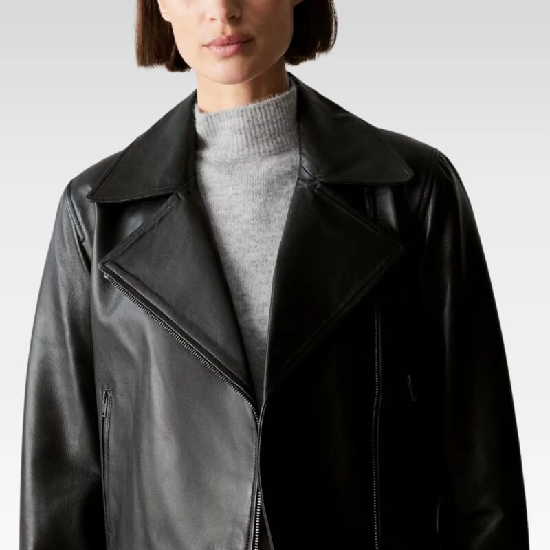 Side angle front view of black leather biker jacket with zippered pockets, worn over black skirt for a chic, edgy look.