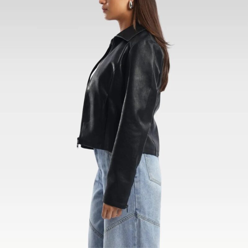 Back view of a black leather jacket worn by a woman with long hair, paired with light blue jeans, highlighting its tailored fit and versatile design for autumn and winter