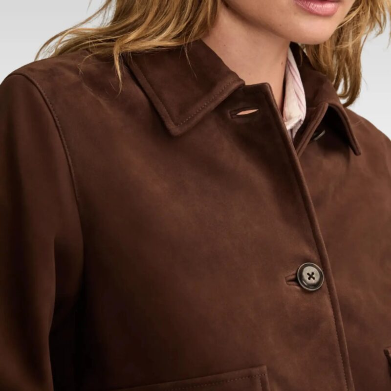 Close-up of the spread collar on a luxurious boxy-crop suede jacket in brown, emphasizing its buttery-soft 100% goat suede finish and elegant design