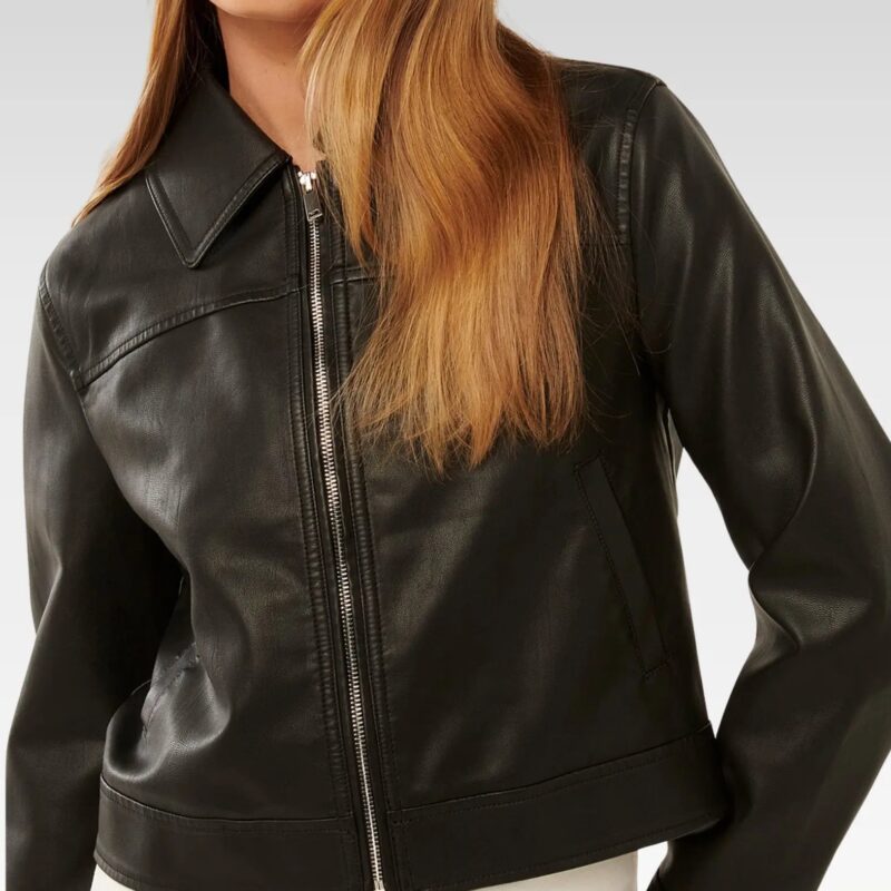 Side profile view of woman in black collared leather jacket with zip-up front, demonstrating the flattering regular fit and premium leather texture