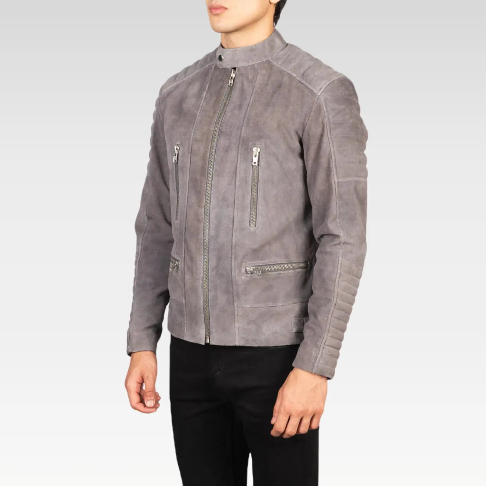 Side view of the Damian grey suede biker jacket with arm raised, emphasizing the zippered cuffs and comfortable fit for a rugged yet stylish appearance.
