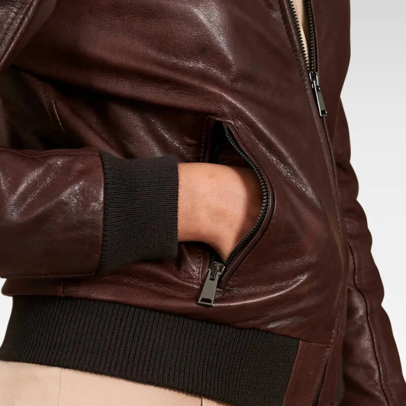 Close-up of the sleeve on a dark brown lamb leather bomber jacket, highlighting the rich leather texture and modern tailoring, ideal for cool-weather styling.