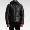 Front view of the Gordon Black Hooded Leather Puffer Jacket displaying its sleek silhouette, high-neck collar, and removable hood.