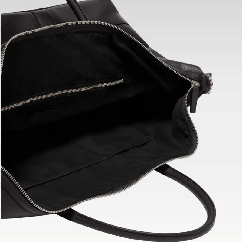 Interior view of the Iron Rose Medium Duffle showing premium full-grain leather lining, spacious main compartment, interior zip pocket, and open organizer pockets designed for travel and gym essentials.