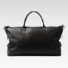 Top view of the Iron Rose Medium Duffle highlighting the smooth full-grain leather exterior, reinforced handles, adjustable side tabs, and secure zipper closure ideal for airline carry-on use.