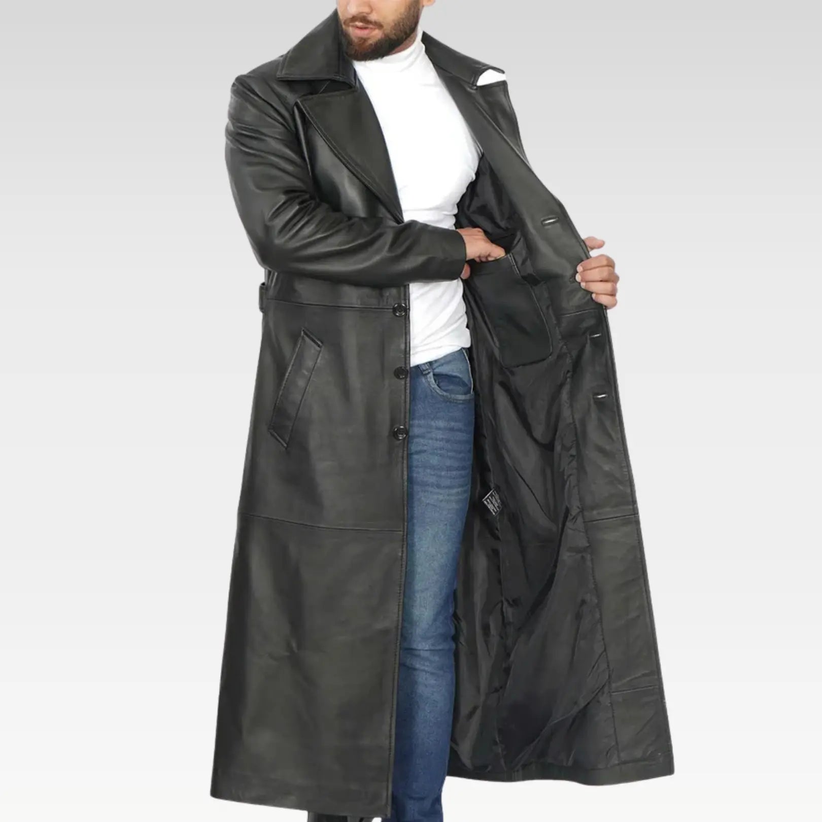 Model wearing Jackson men’s black leather long duster coat open at the front with wide lapels.