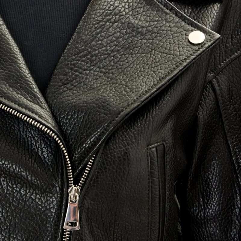 Side profile of black pebbled lambskin leather biker jacket showing adjustable string details and fitted silhouette with elastic back panel