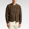 Man wearing a brown leather jacket on a plain background