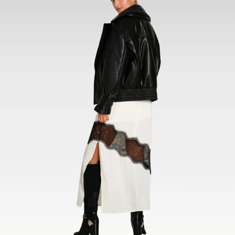 Model walking in the Love Drunk Black Leather Bomber Jacket styled with a mini skirt for an edgy street-chic look.