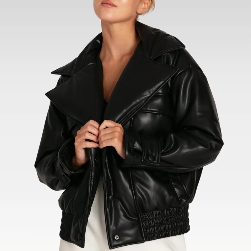 Love Drunk Black Leather Bomber Jacket styled with hands in welt pockets, highlighting the elastic waistband and bold fit.