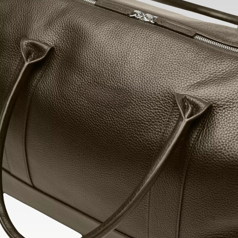 Close-up of brown pebble grain leather on the Obsidian Premium Leather Duffle, showcasing durable texture and premium craftsmanship.