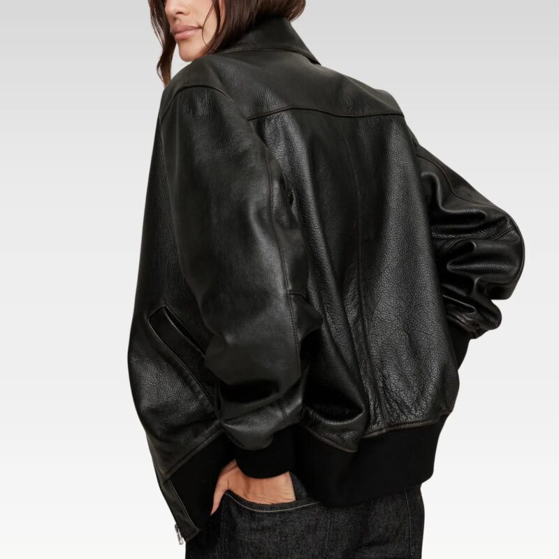 Close-up of bomber jacket's front pocket and zipper, showcasing craftsmanship and functionality.