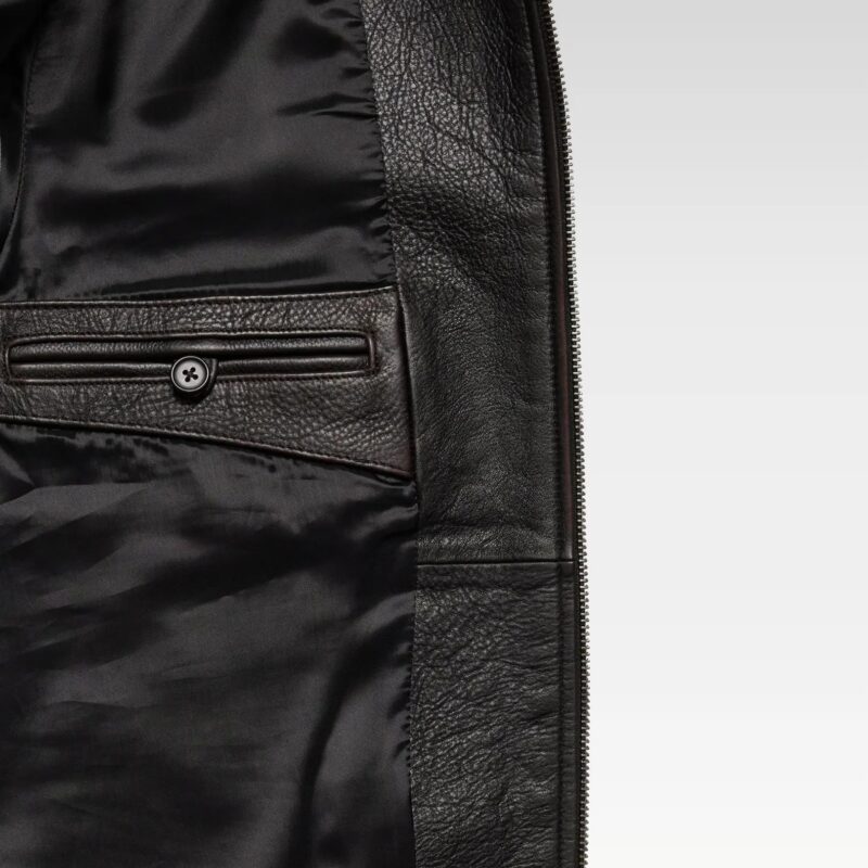 Close-up of model in oversized bomber jacket showing point collar, zip-front closure, and luxe leather finish