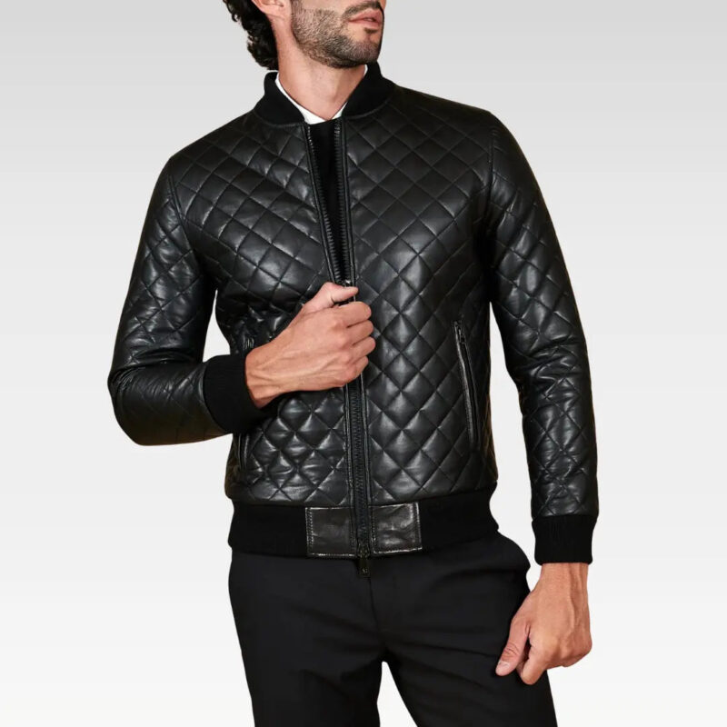 Model posing in the Paul black diamond-quilted leather bomber jacket with hand on chest, highlighting luxurious lambskin leather and tailored fit.