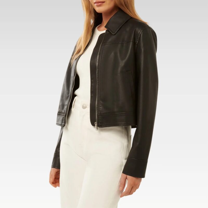 Woman wearing black collared leather jacket over white top, showcasing the cropped fit and structured collar design