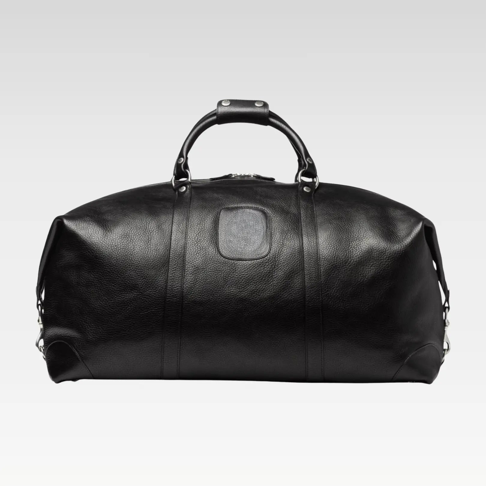 Front view of the Rogue premium black full-grain leather travel duffel bag showcasing its rich leather and structured shape.