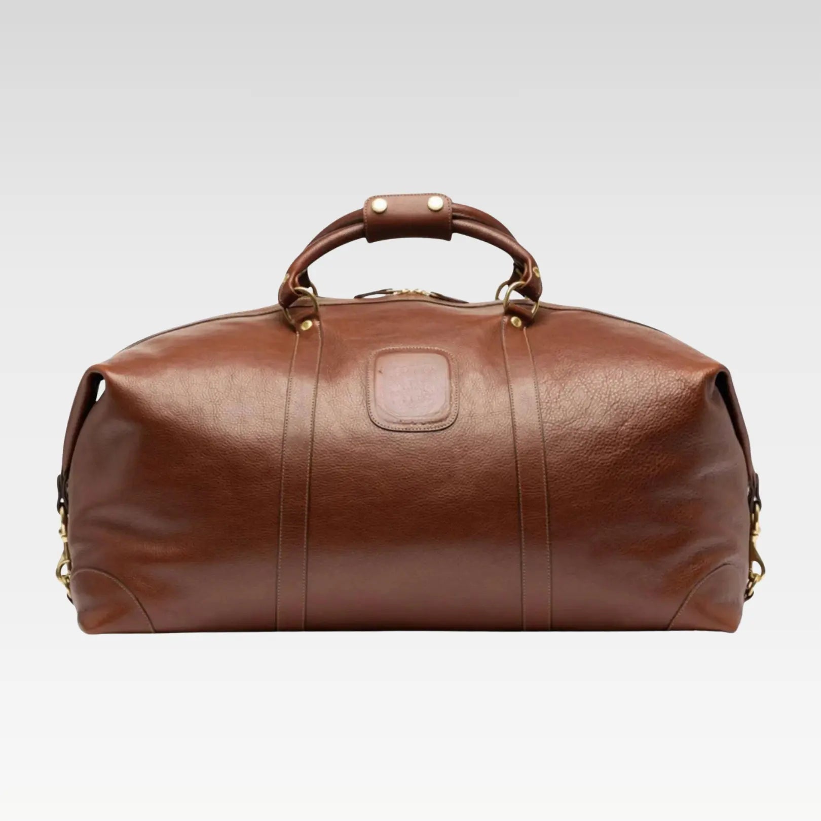 Front view of the Rogue premium full-grain leather travel duffel bag showcasing its rich brown leather and structured shape.