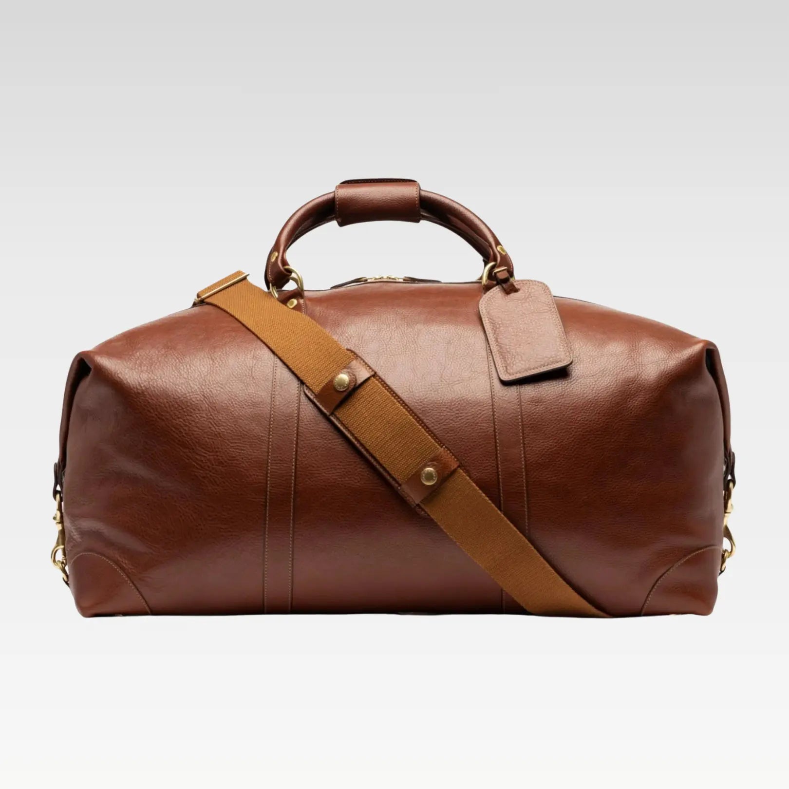 Rogue full-grain leather travel duffel bag displayed with its detachable, adjustable shoulder strap attached.