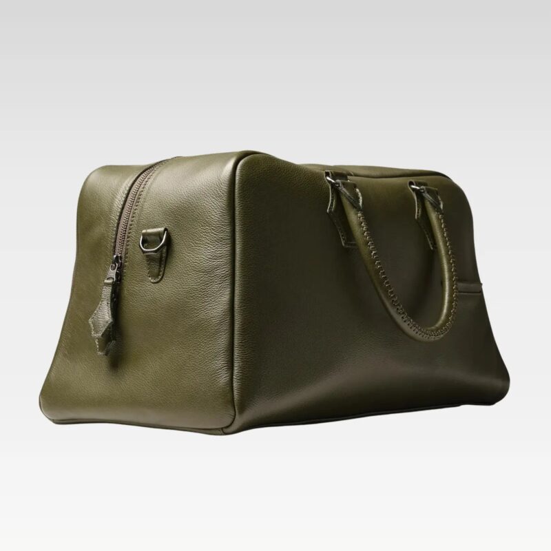Side profile of the green Sable duffle bag, showing compact, carry-on-friendly dimensions and structured leather design.