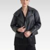 Woman wearing the Sasha biker black leather jacket in  styled with a beige dress and handbag, showcasing the cropped boxy fit and edgy biker details.