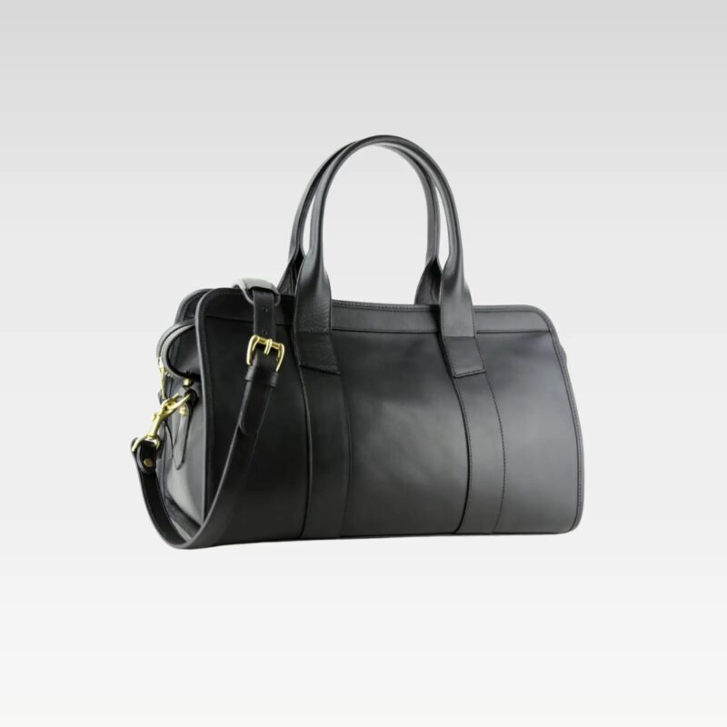 Side angle of the black Signature Weekender Leather Duffle highlighting smooth leather craftsmanship, durable construction, and solid brass zipper