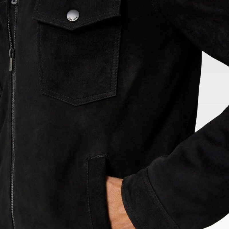 Close-up of suede trucker jacket pocket with snap button detailing, highlighting premium suede leather texture.