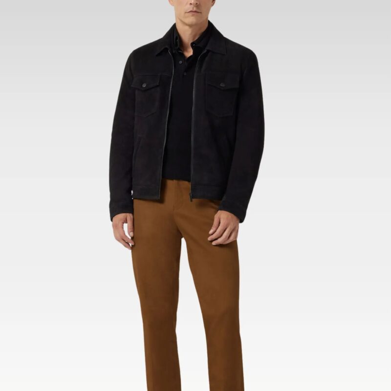 Side profile of a men’s suede leather trucker jacket in black, showing zip fastening and tailored fit with brown chinos.