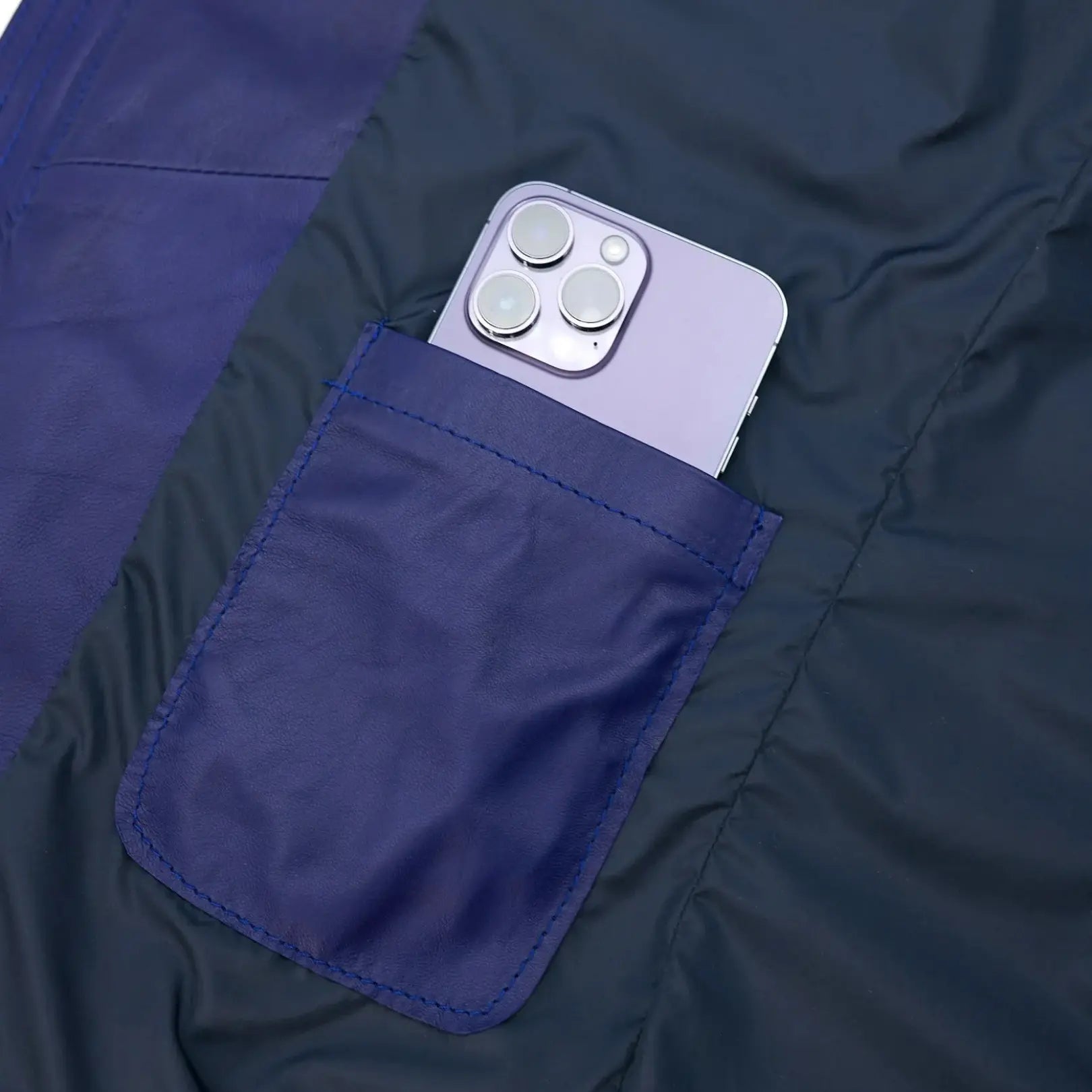 Folded Teo Blue Hooded Lamb Leather Puffer Jacket showing smooth full grain leather and compact design for travel and easy storage.