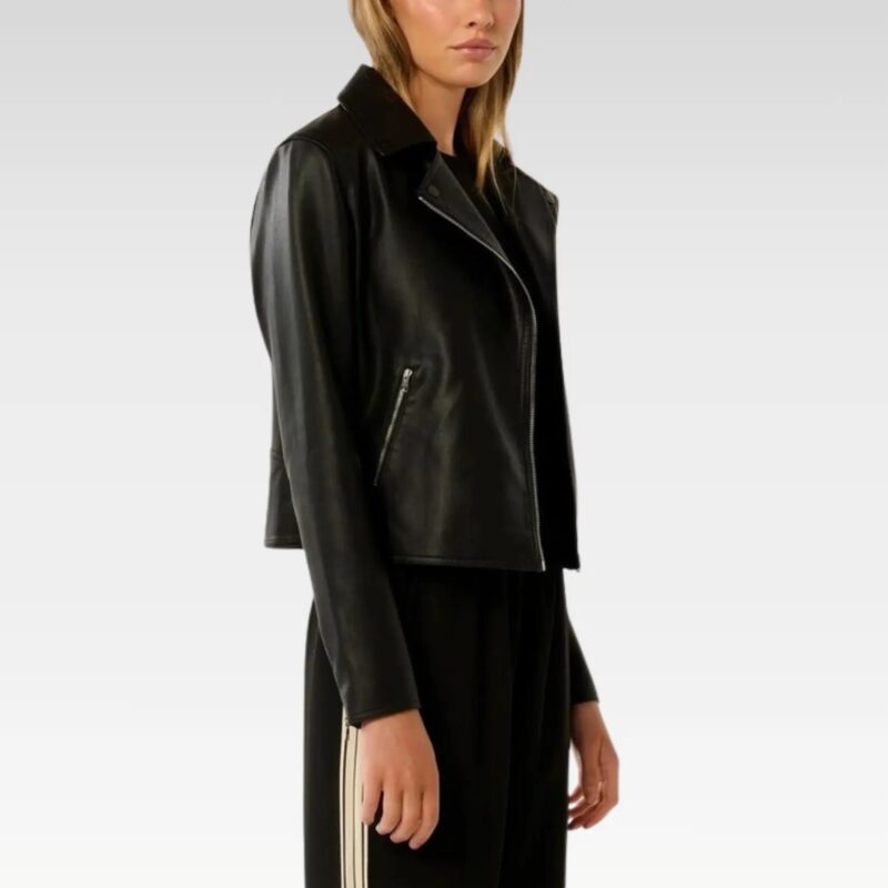 Close-up detail of black vegan leather biker jacket showing asymmetrical zip front closure and premium leather texture