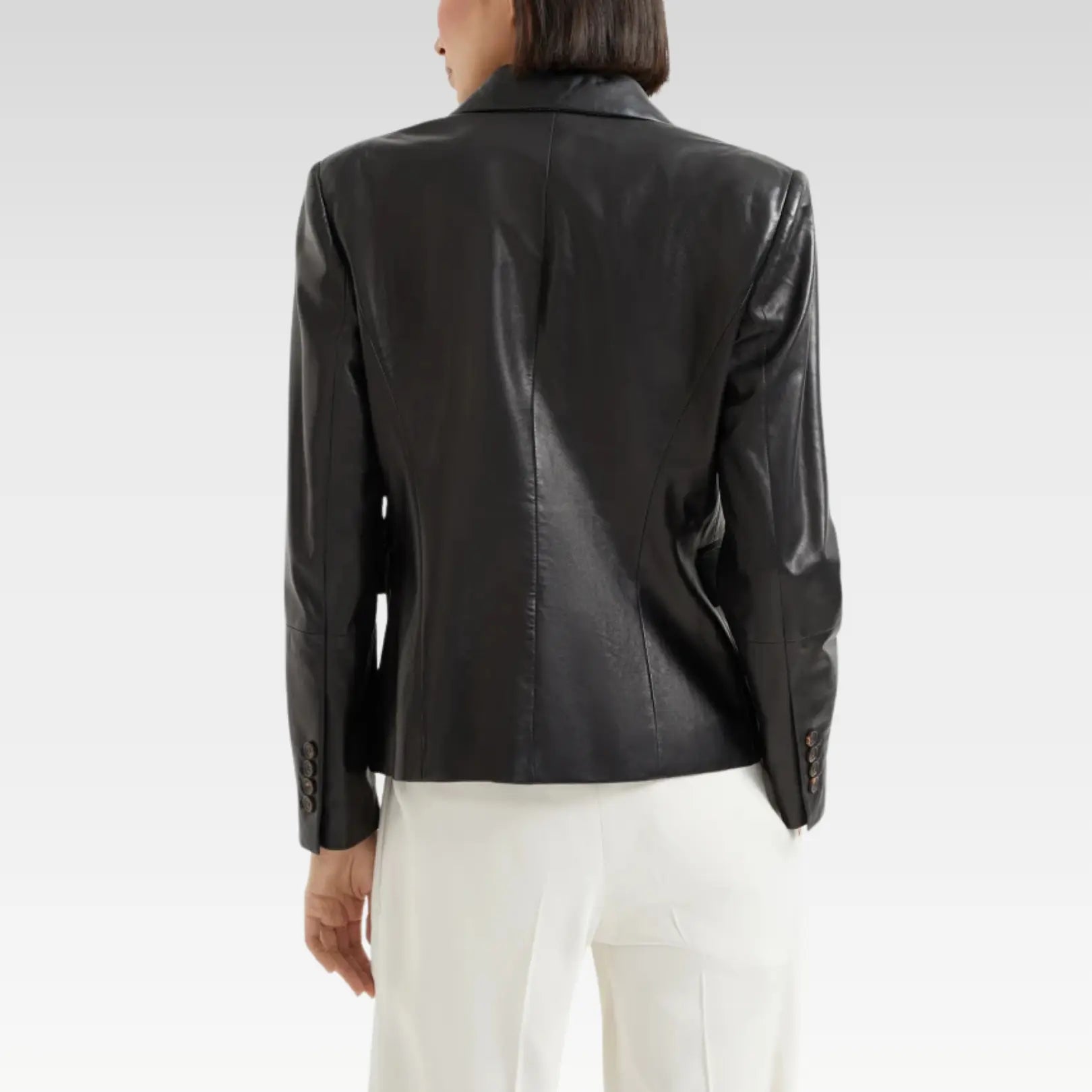 Back view of a stylish women's black leather blazer with a tailored fit, showcasing premium lambskin leather and a modern silhouette, perfect for chic day-to-night looks.