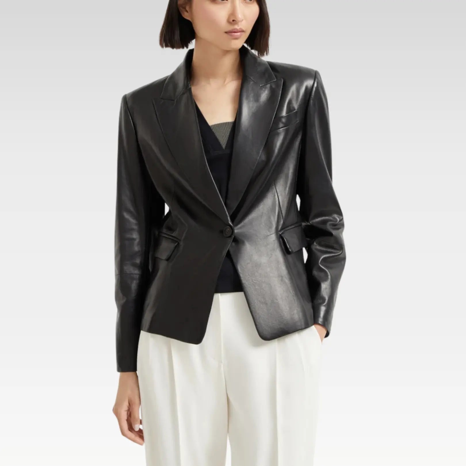 Full outfit featuring a women's black leather blazer paired with white trousers and a bag, showcasing a trendy day-to-night look.