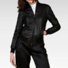 Women's cropped washed leather bomber jacket in black, close-up of the pocket detail, showcasing the modern washed texture and durable sheep leather construction.