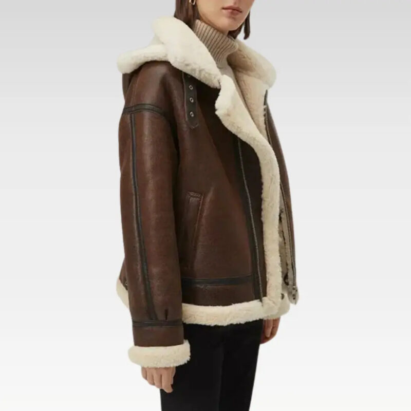 Side view of a women's faux shearling leather jacket in rich dark brown, featuring a removable hood and cozy shearling lining, perfect for winter fashion.