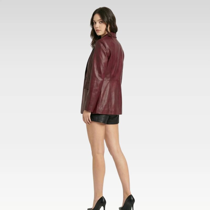 Side profile of women’s burgundy leather blazer paired with black outfit